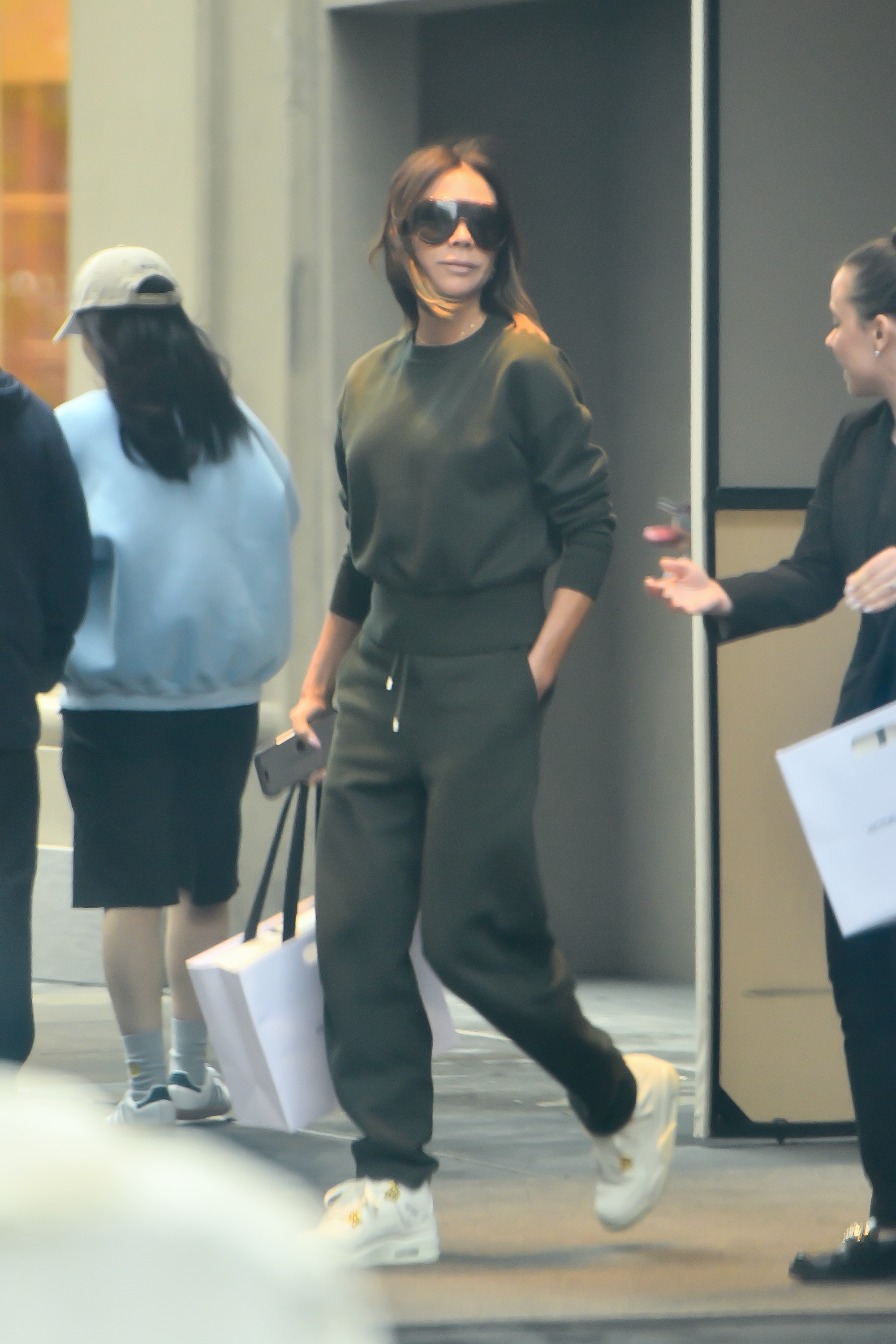 Victoria Beckham wears trainers at the airport.