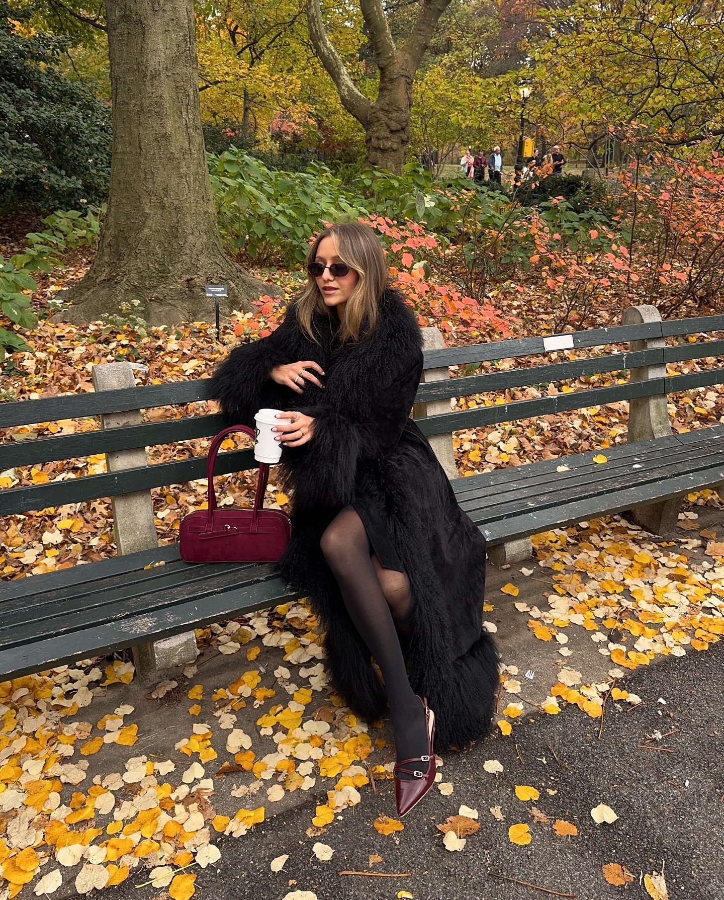 @chasemarieee wearing a Penny Lane coat while sitting on a bench.