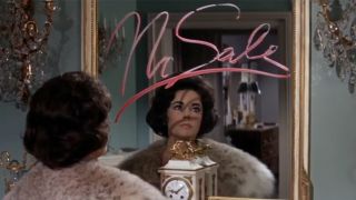 Elizabeth Taylor sitting at mirror with "No Sale" written in lipstick on it in Butterfield 8