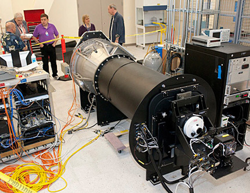 Visitors are briefed on the operation of the telescope simulator with the High-Speed Imaging Photometer for Occultations, or HIPO, instrument attached during the SOFIA science and education media day on June 8, 2011 at the Dryden Aircraft Operations Facility in Palmdale, Calif.