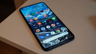 A Google Pixel 5 from the front, on a table, with the screen on