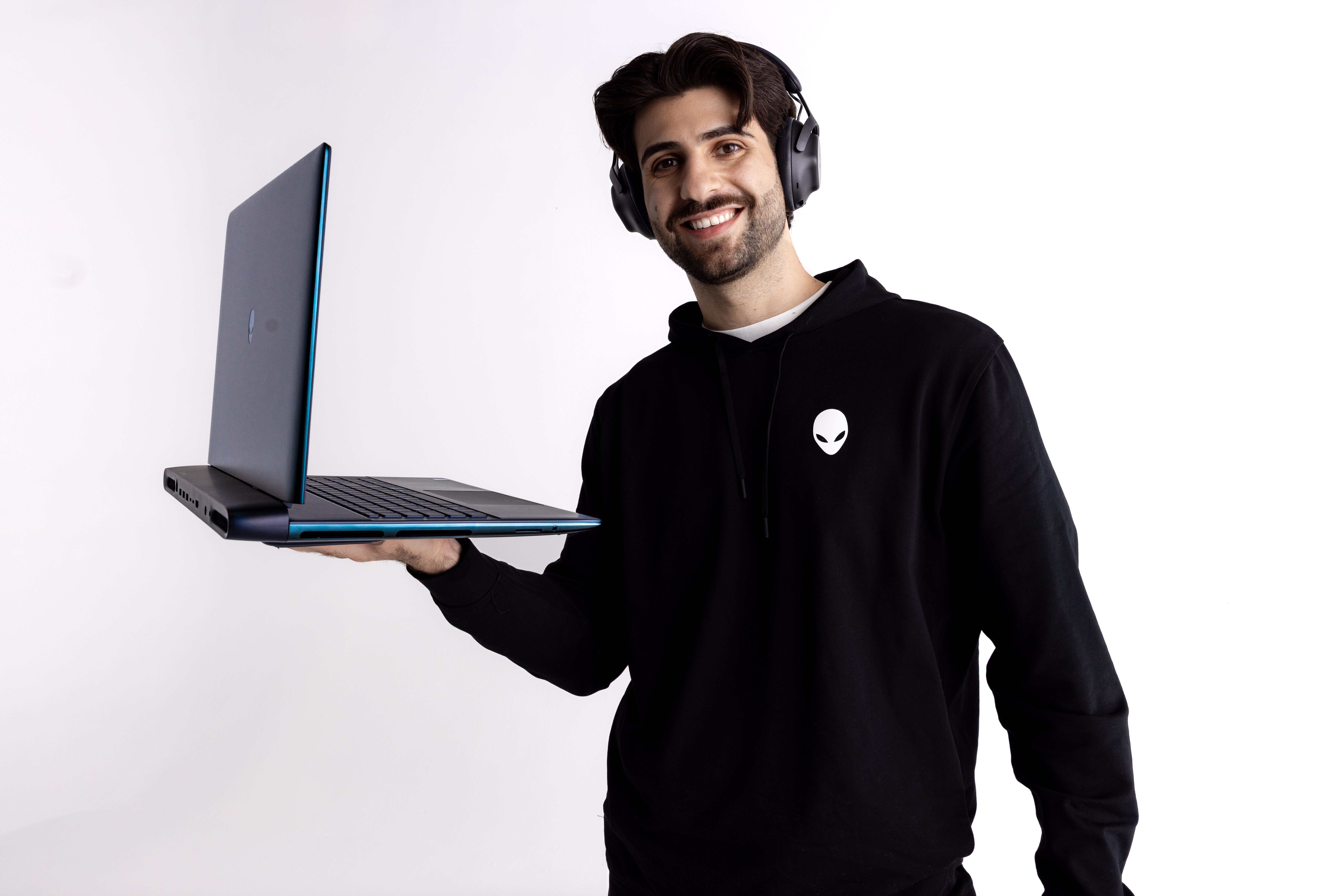 SypherPK holds up an Alienware laptop