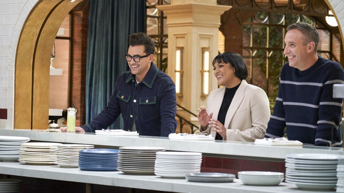 Dan Levy, Sohla El-Waylly and Will Guidara laughing behind a countertop in The Big Brunch