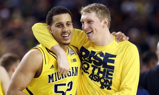 Jordan Morgan and Blake McLimans of the Michigan Wolverines celebrate after the Wolverines defeat the Syracuse Orange 61-56 in the 2013 NCAA Men&amp;#039;s Final Four Semifinal at the Georgia Dome on 