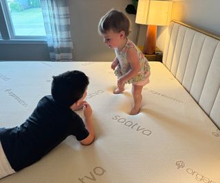 Two of Alex's kids playing on the Saatva Contour5 Mattress.