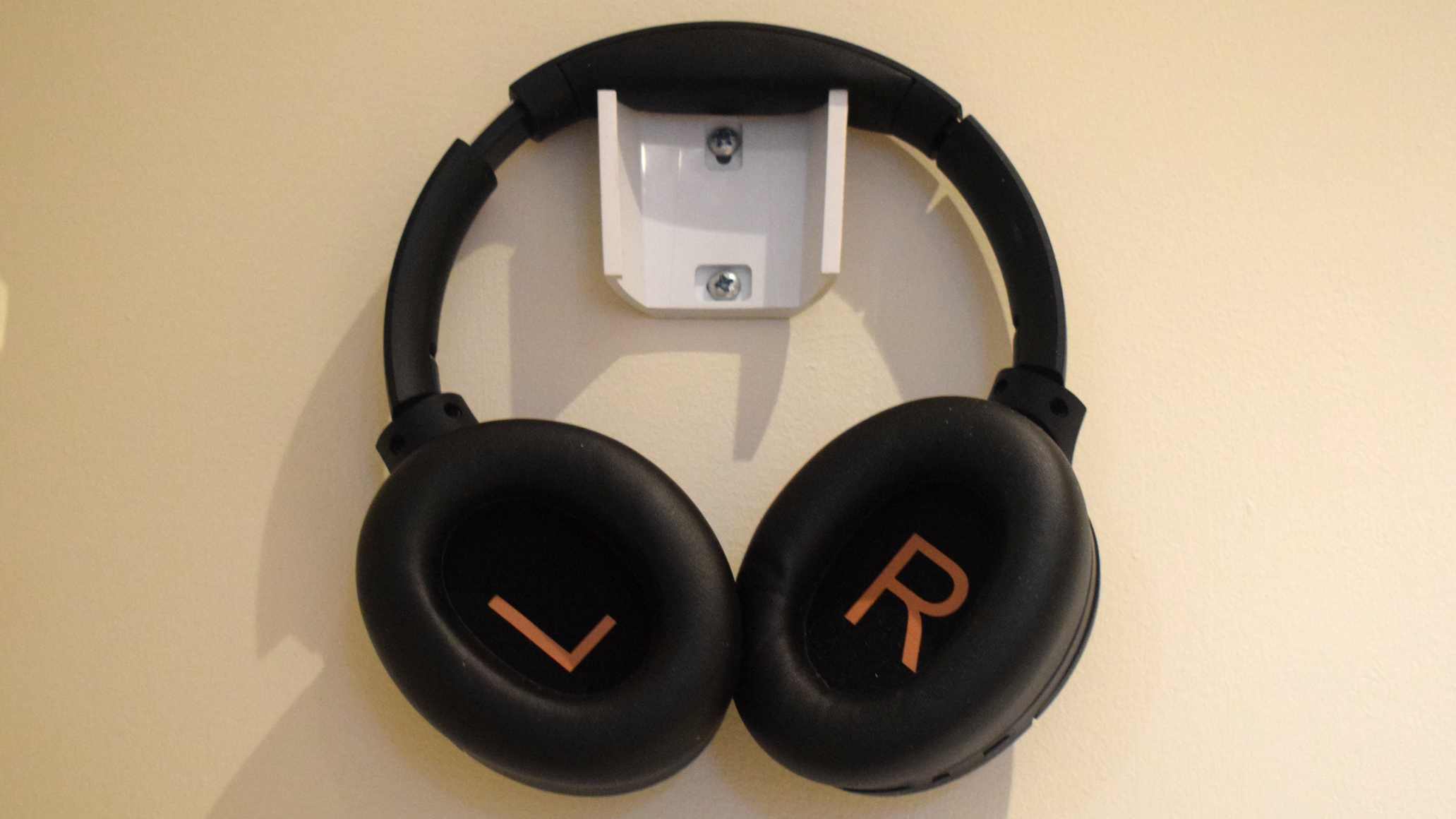 The Soundpeats Cove Pro hanging up, and with the inside of each cup facing outwards.