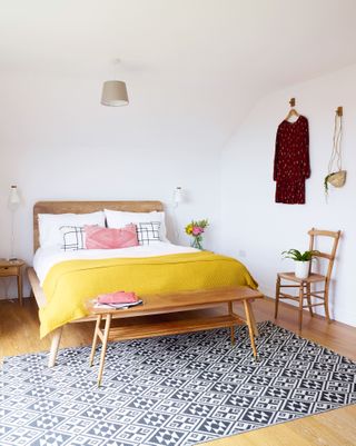 Scandi style modern bedroom with yellow throw