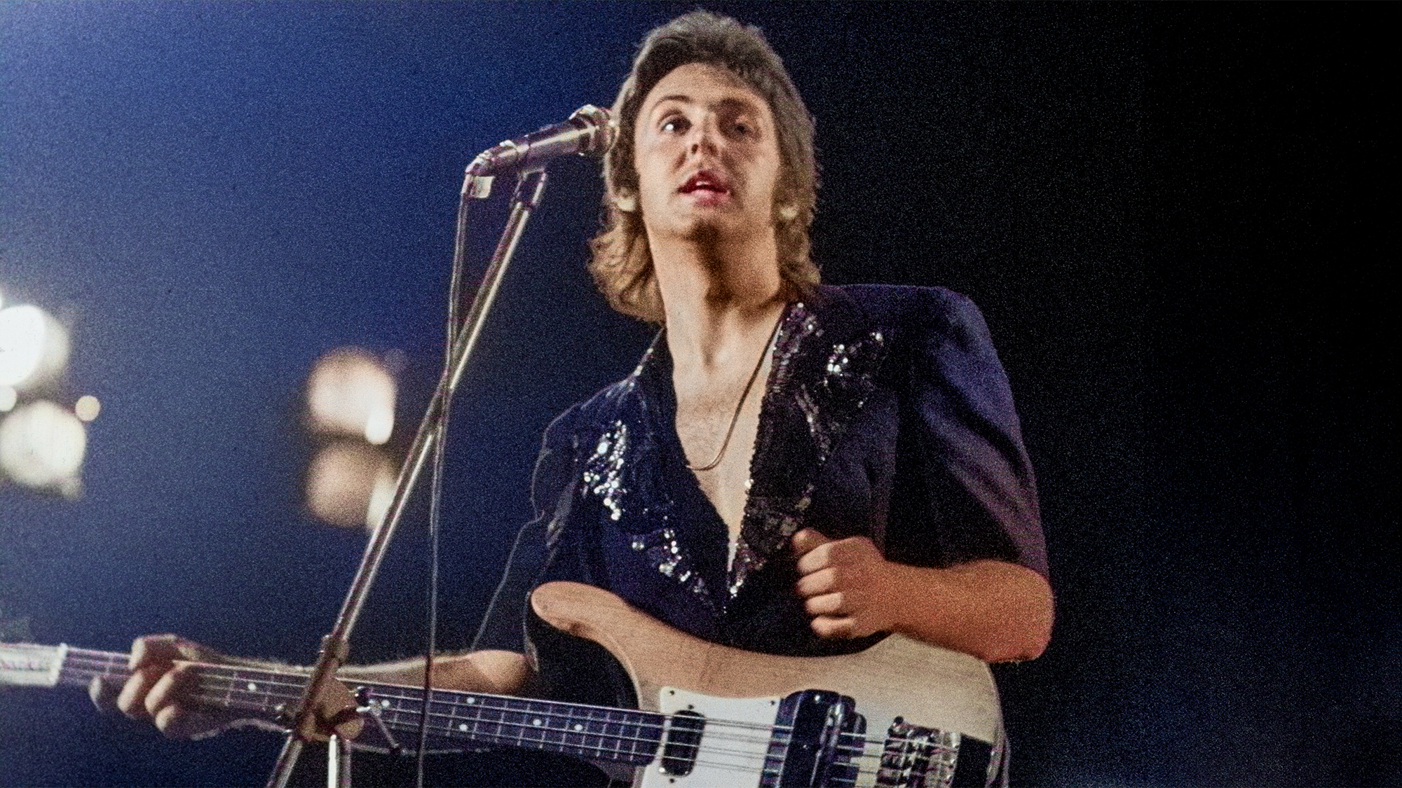 Paul McCartney of Wings performs live on stage at The Theatre Antique on 13th July 1972 in Arles, France. He plays a Rickenbacker 4001S bass guitar.