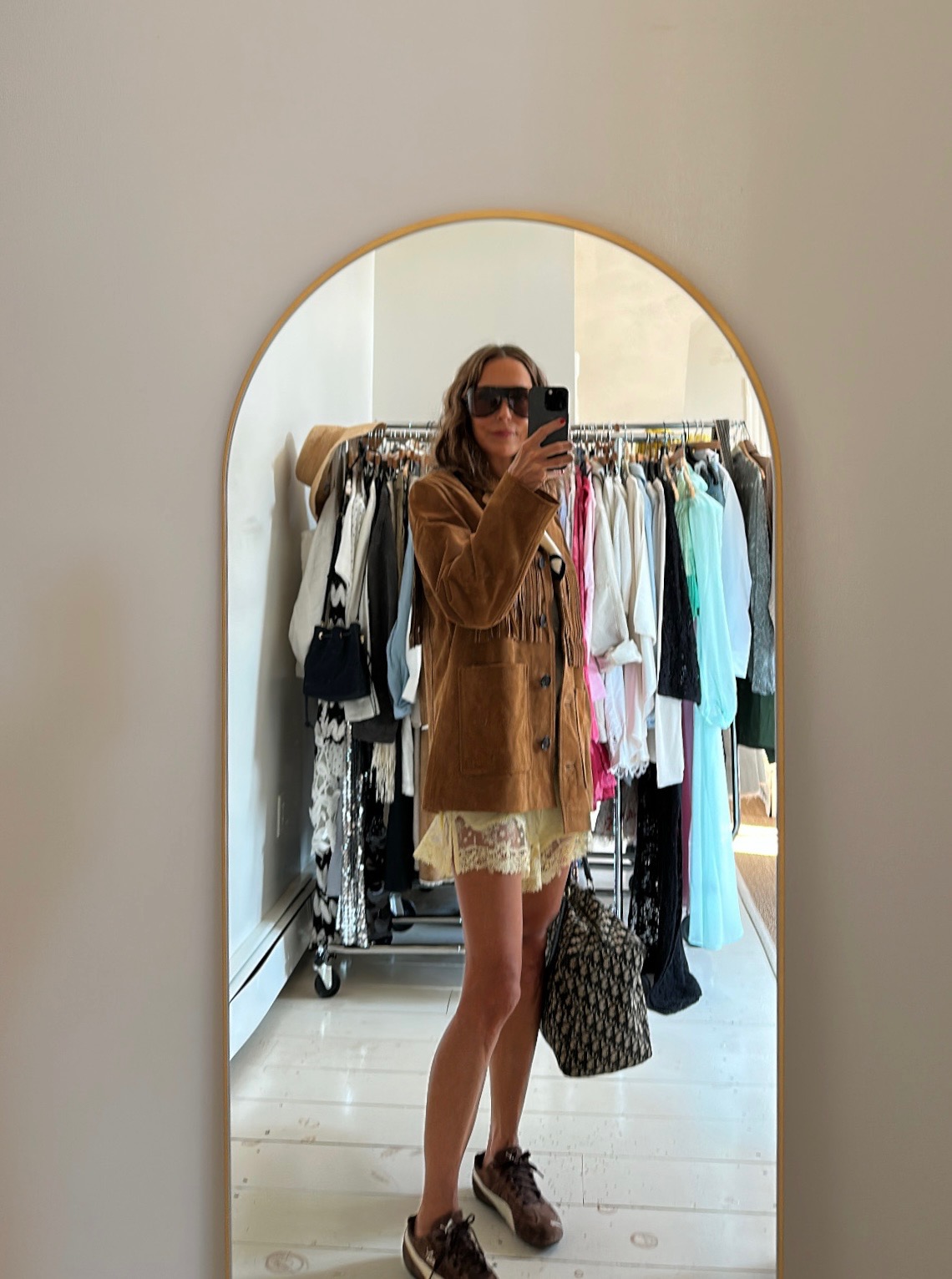 a photo of fashion content creator Larissa Mills wearing trendy shoes and glasses