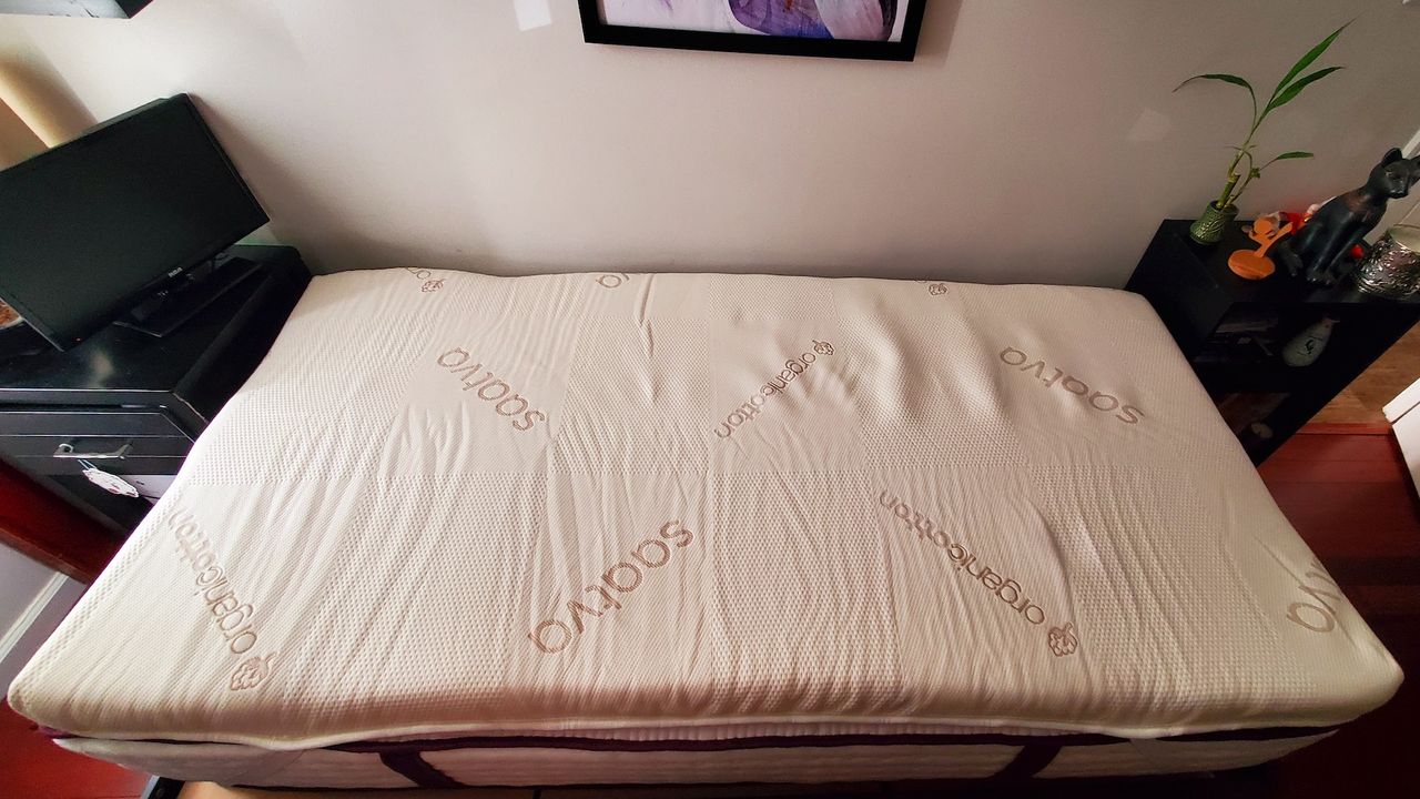 The Saatva Graphite Mattress Topper on a tester's twin-size bed.