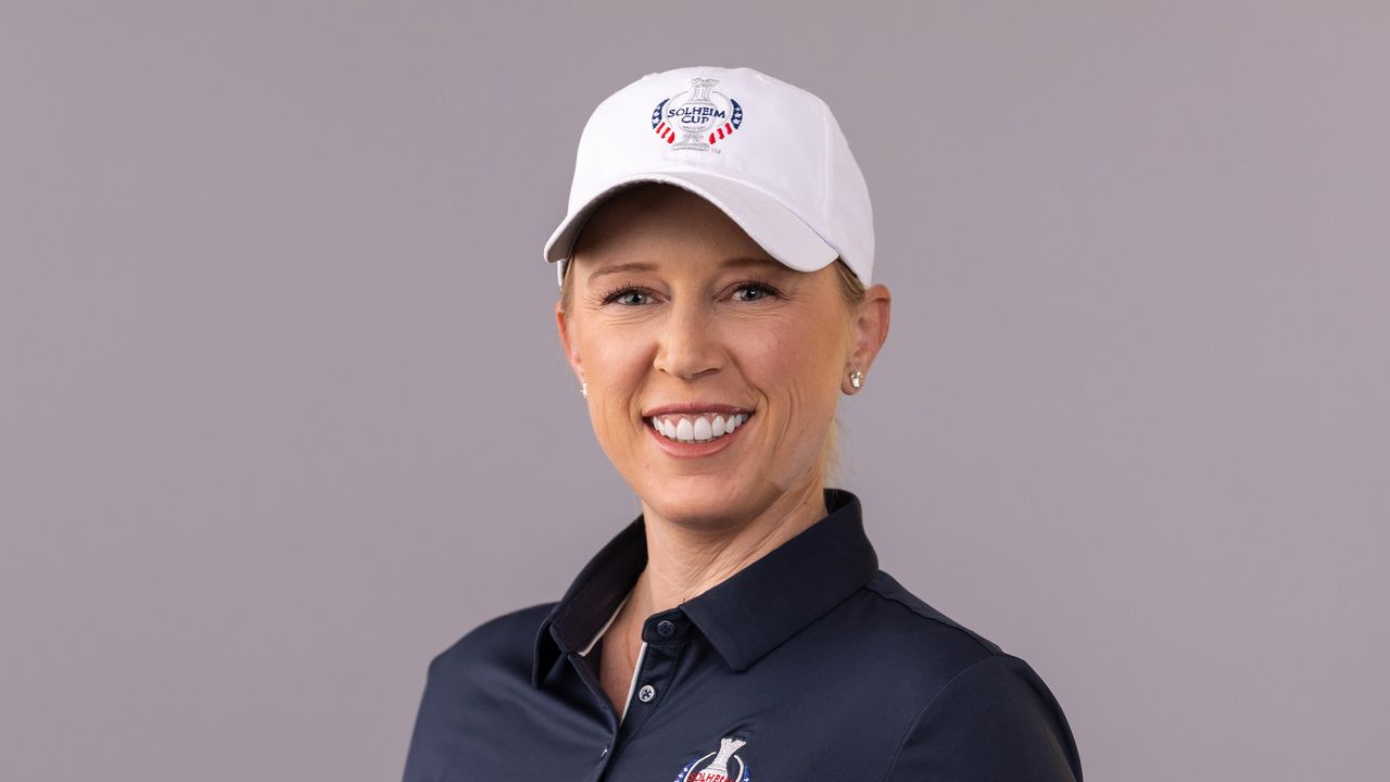 Morgan Pressel smiles while wearing 2024 Solheim Cup gear