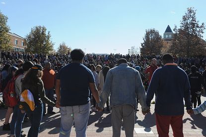 Students pray during protests over racism at the University of Missouri.
