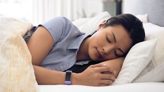 Woman asleep wearing Fitbit