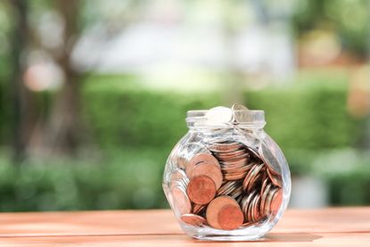 Saving money box with a stack of coins