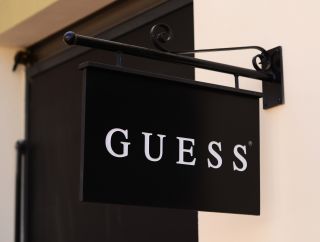 Black and white hanging Guess sign