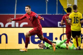 Cristiano Ronaldo celebrates after scoring his 100th goal for Portugal in a match against Sweden in 2020.