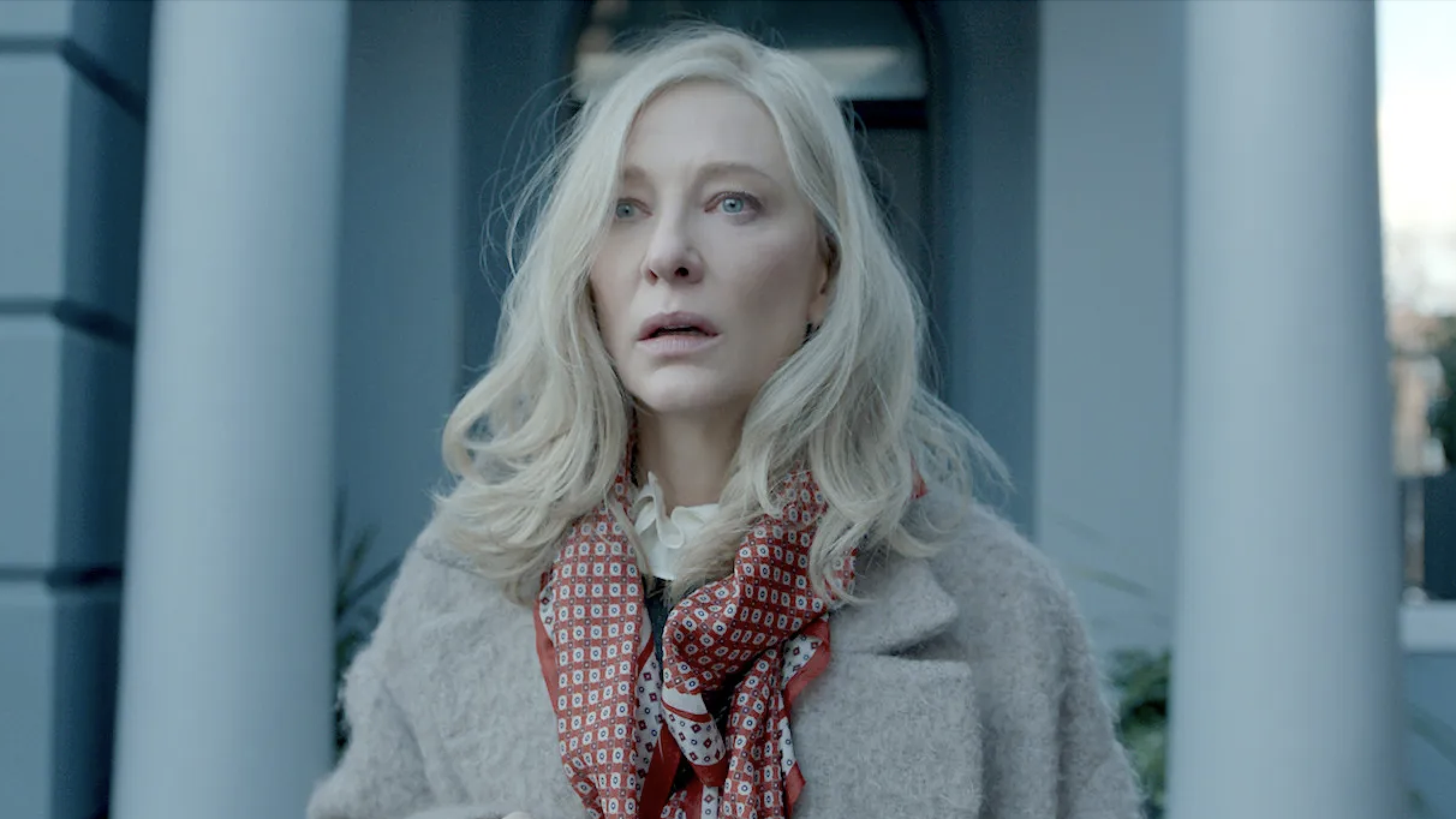 Actress Cate Blanchett, wearing warm winter clothes, looks shocked in front of an expensive door in the original Apple TV+ disclaimer