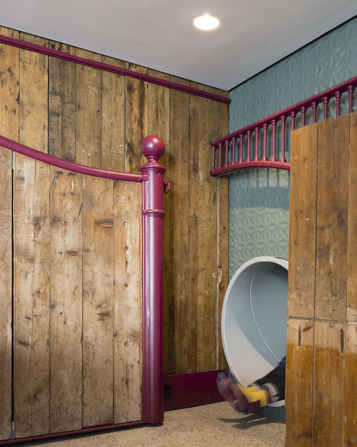timber cladding around a grey slide