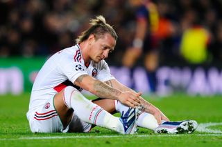 AC Milan defender Philippe Mexes looks dejected after a defeat to Barcelona in the Champions League in March 2013.