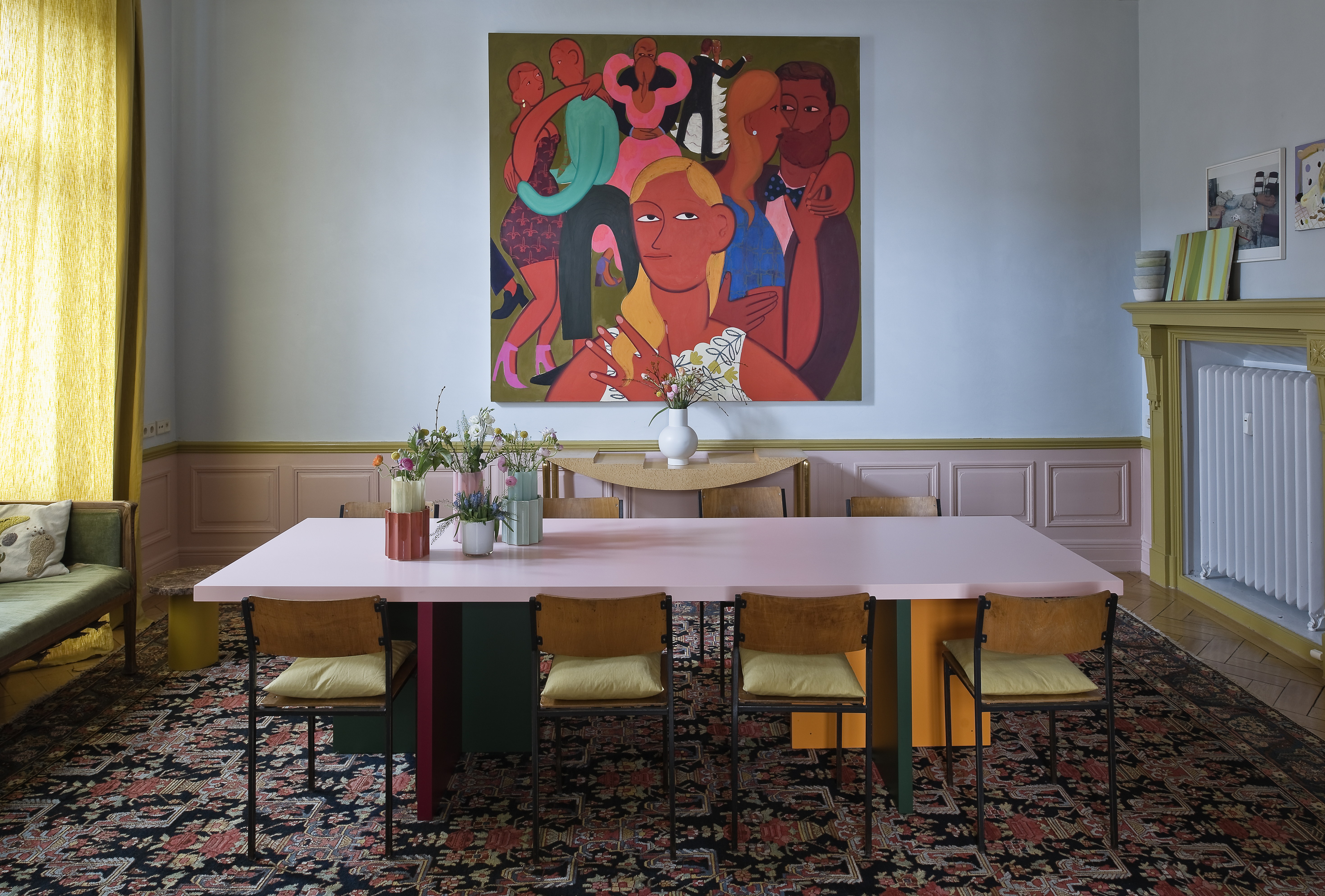 A contemporary dining room with trim painted in pink and khaki green