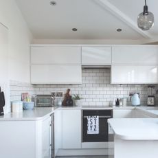 A white kitchen with ceiling downlights