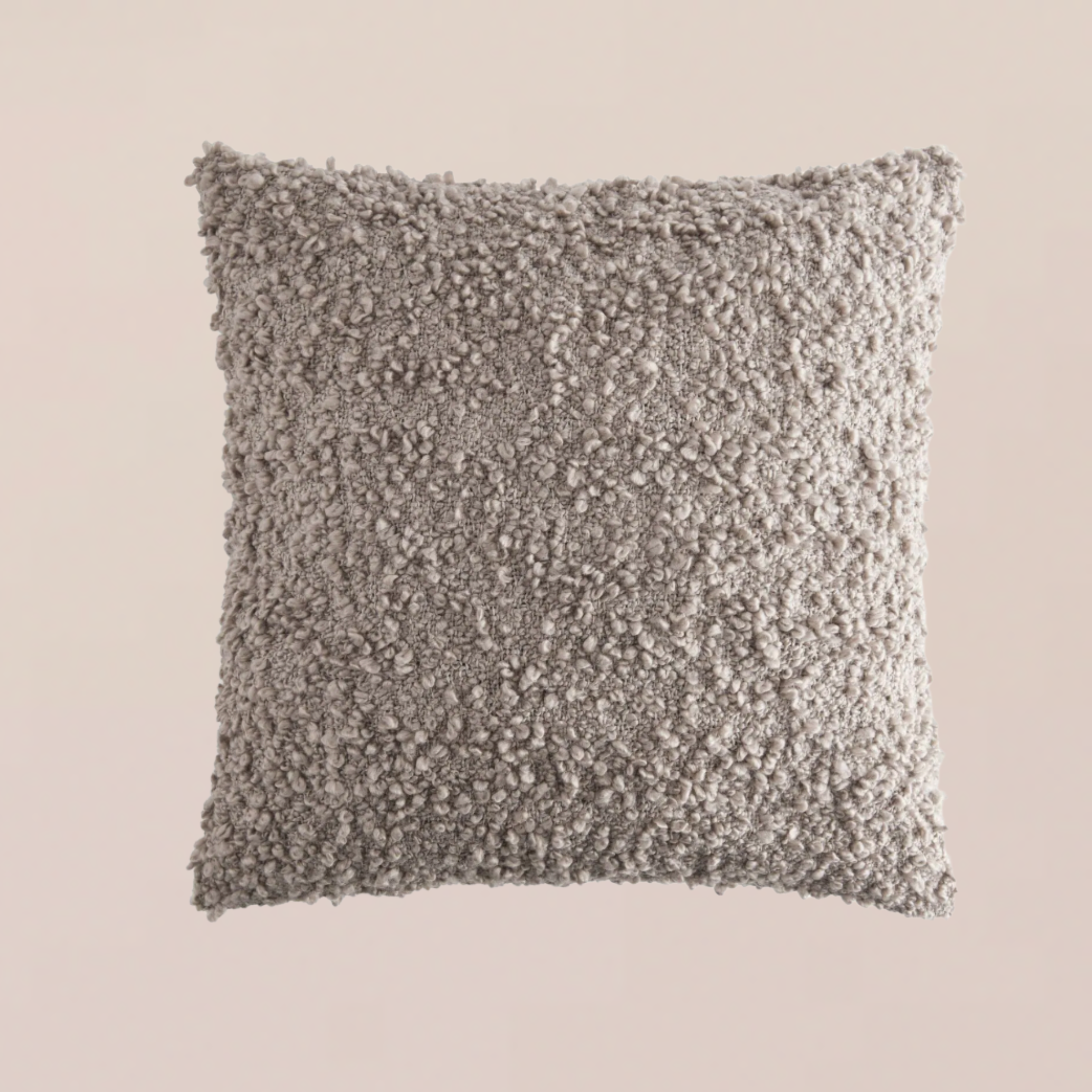 A grey boucle pillow