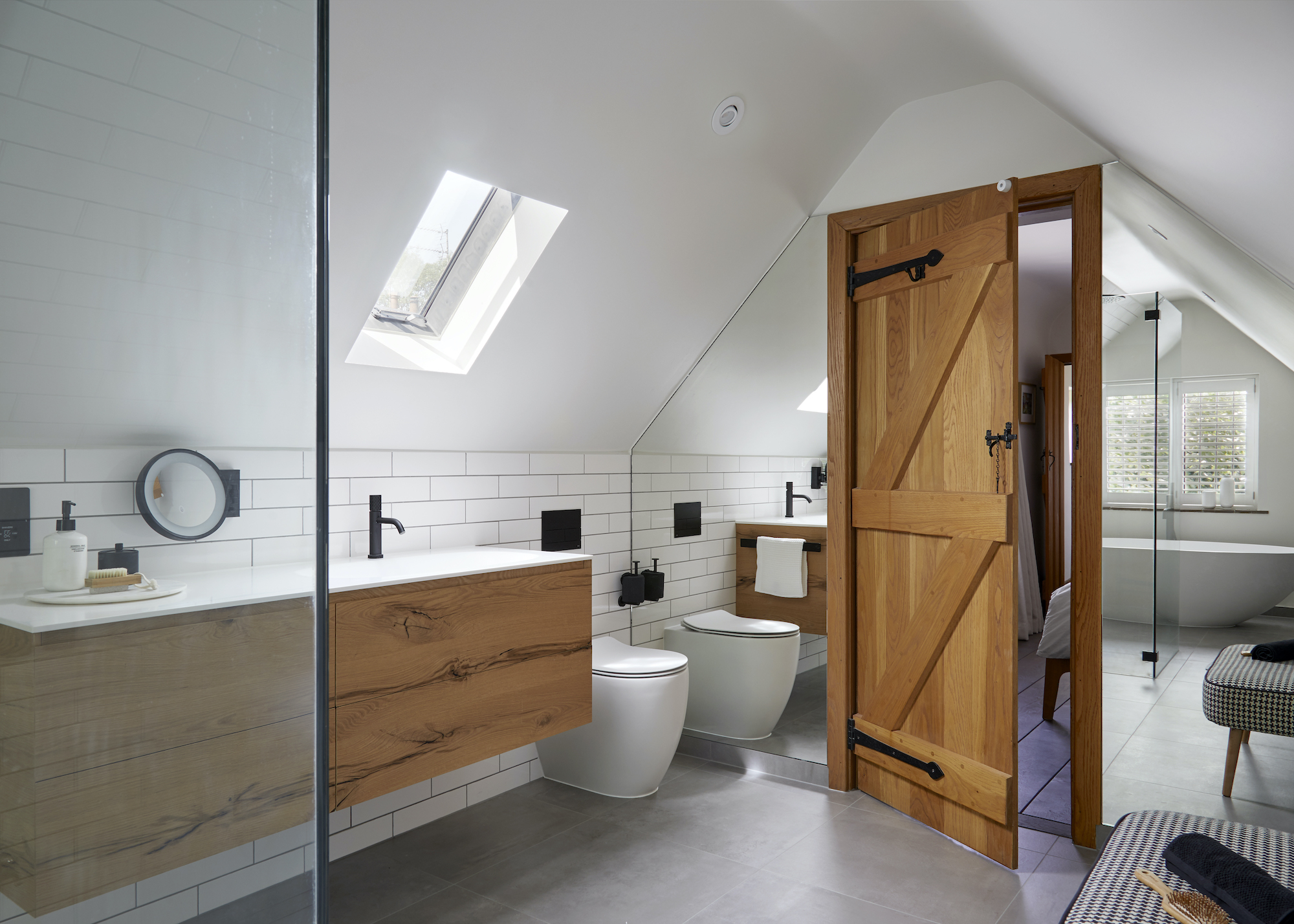 loft bathroom in white and timber with lots of mirror