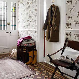 entrance with geometric patterned floors and brown coat