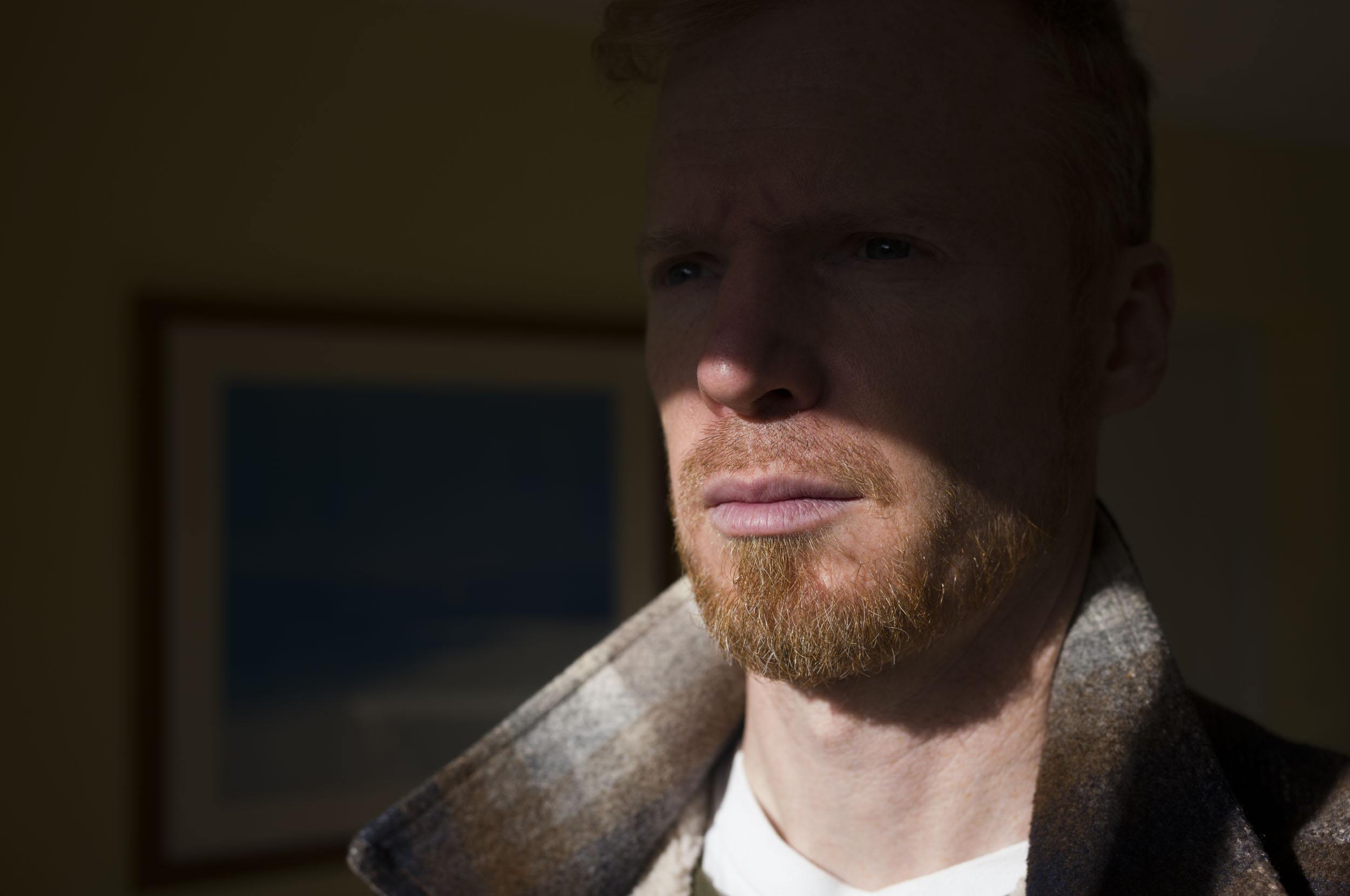 Leica M EV1 sample gallery: man partly in shade and light by window