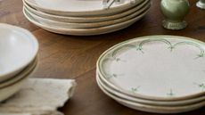 piles of vintage looking plates on a wood table