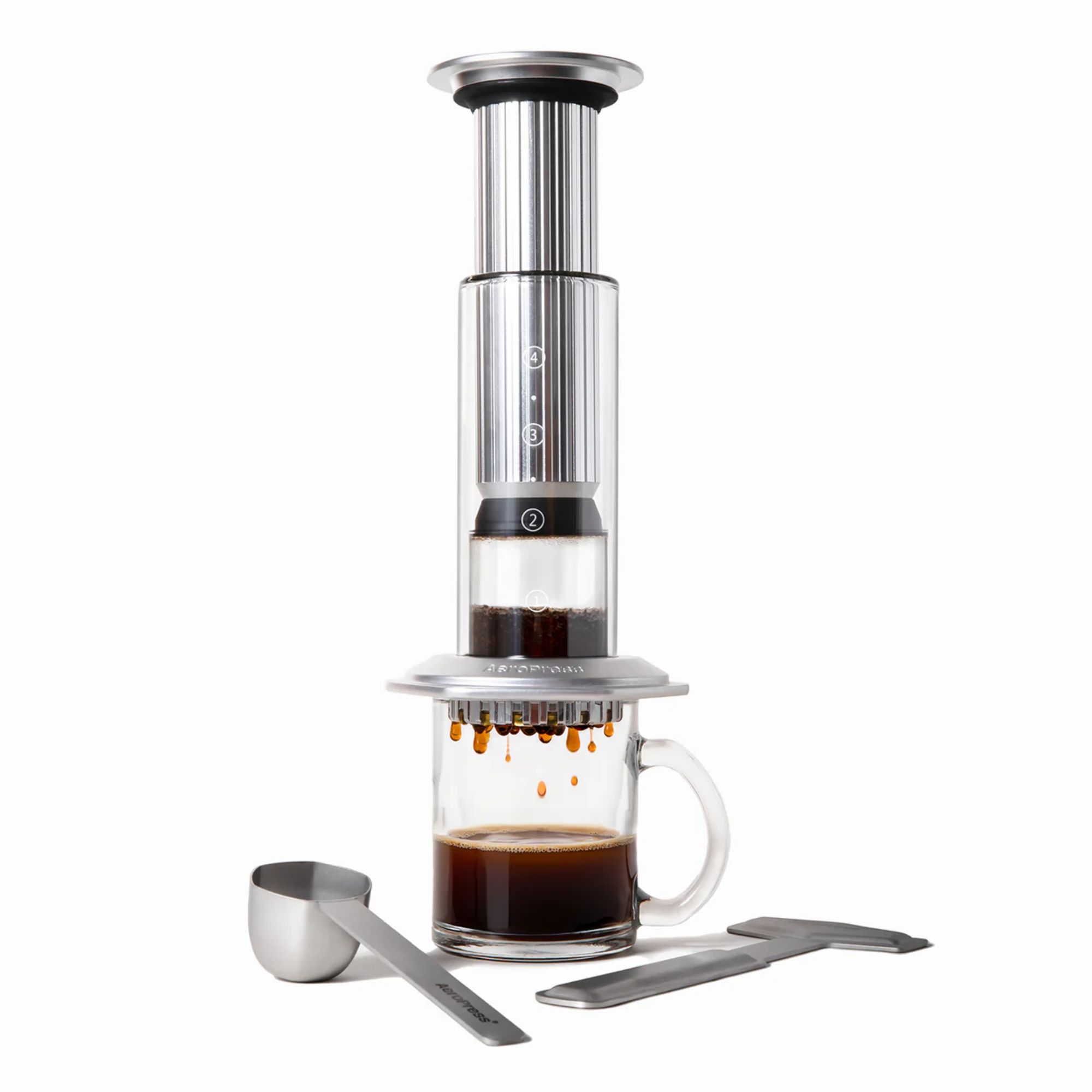 An Aeropress Premium making coffee against a white background