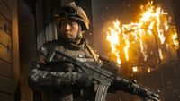 Key art for MW4, depicting a Korean soldier cautiously stood next to a wall as a building burns in the background.