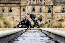 Tinie Tempah stands beside the Rise pram and pushchair from the new Rise by Tinie range, available exlcuslvely at John Lewis