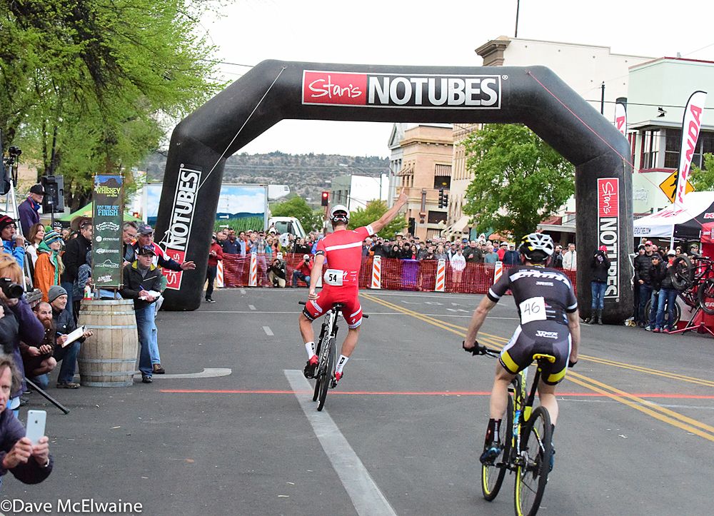 Sam Gaze (Specialized) celebrates in front of Derek Zandstra at the finish