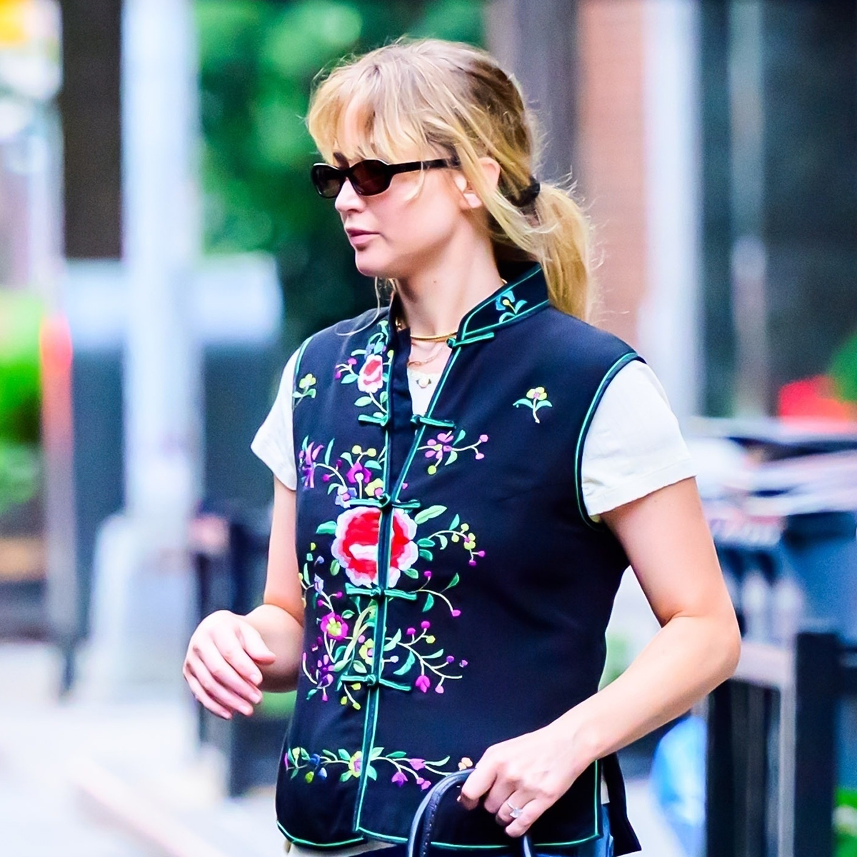Jennifer Lawrence wearing a navy vintage vest and white T-shirt