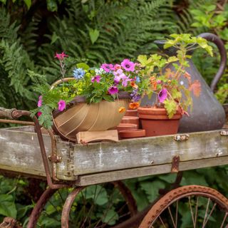 fresh flowers in a trug on a flower cart