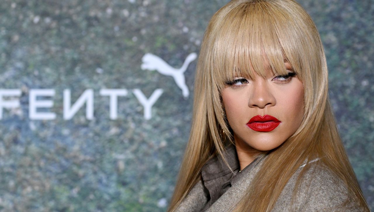 Rihanna attends a Fenty Puma event in London with blonde hair and a gray coat