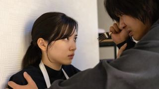 A man (right) holds a woman (left) against the wall and threatens her with a fork, in 'Burn the House Down.'