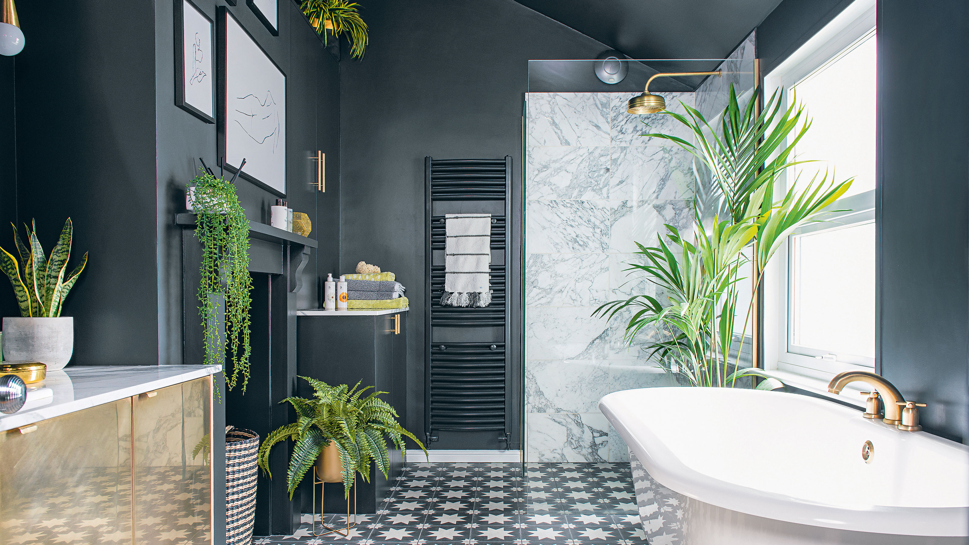 Blue bathroom with white bath and shower enclosure and patterned tiles