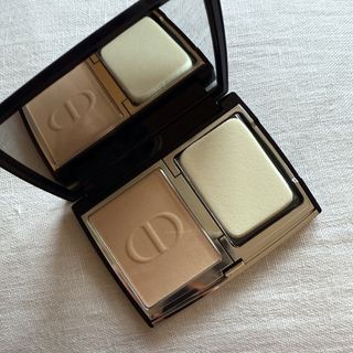 An open DIOR Forever Natural Velvet Compact Foundation set against a white linen background