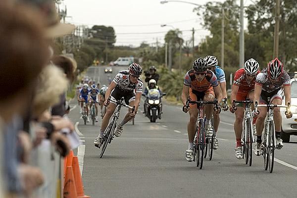 The lead group had split and were coming back to the peloton in the final six laps.