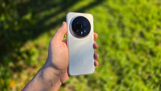 In-hand image of the Honor Magic8 Pro against a background of grass