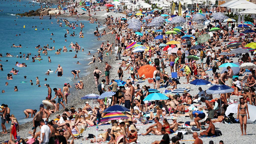 Tourists enjoy the beach along the &quot;Promenade des Anglais&quot; on the French riviera city of Nice, on July 14, 2025. 