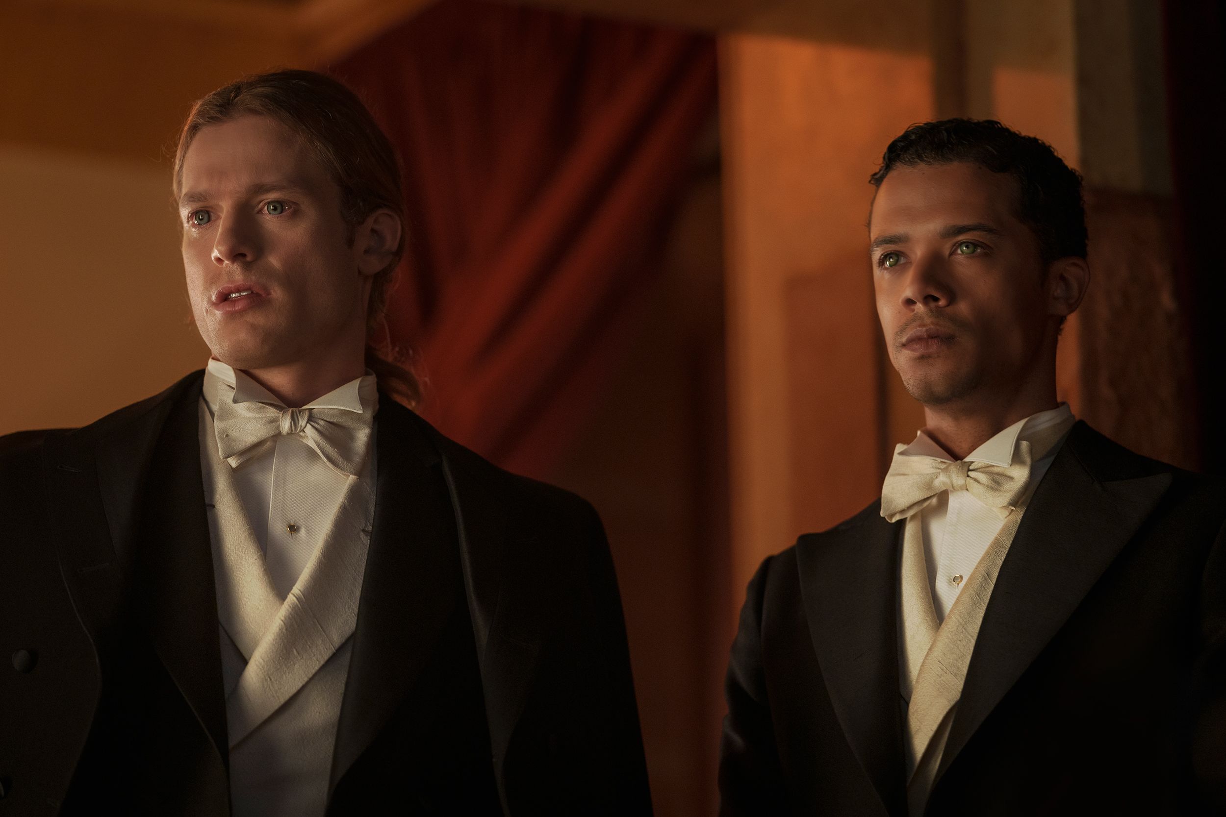 sam reid and jacob anderson as lestat and louis wearing suits and white bowties in the 1700s timeline of interview with the vampire