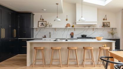 Open kitchen shelving in white beige kitchen decorated with plants and dinnerware