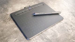 A Wacom Intuos Small drawing tablet on a desk