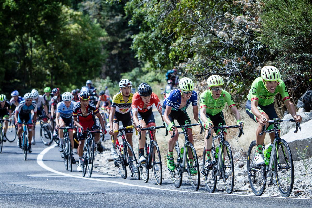 Riders climb Little Cottonwood Canyon as the TV moto goes down in the background