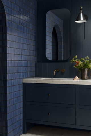 dark blue bathroom with tiles and paneling
