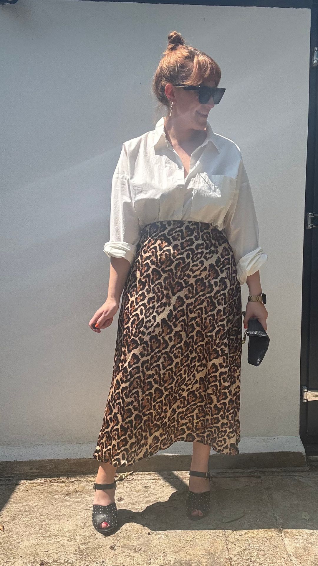 matilda wearing a white shirt tucked into a leopard print skirt