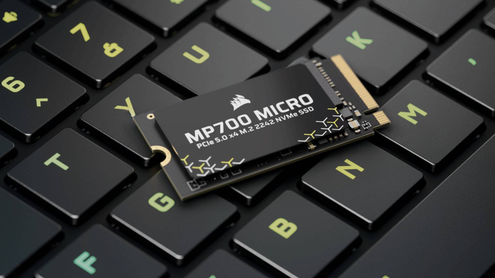 Image of the small form factor MP700 Micro drive sitting on a gaming laptop keyboard.